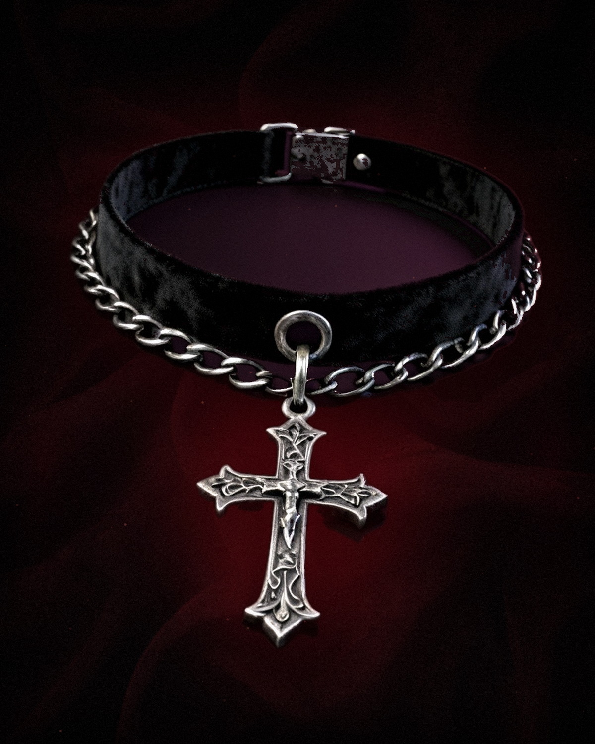 The Noctis Choker — a black leather gothic choker with an ornate silver cross on deep red velvet